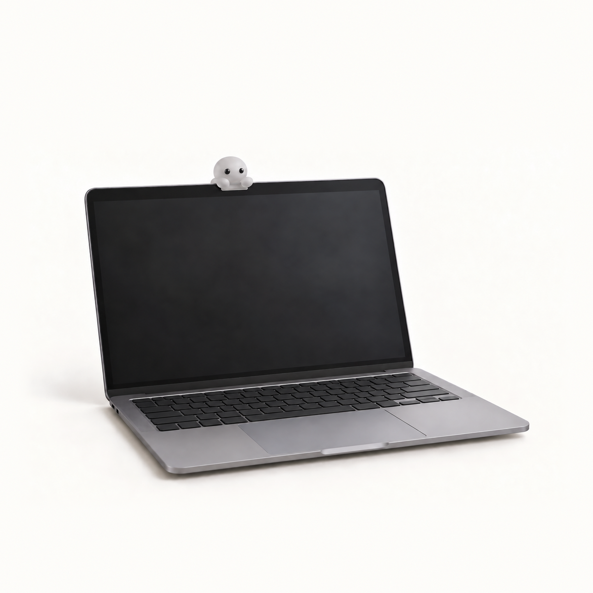 The MacBook Perch in the Clear colourway, a slim frosted ledge on a laptop lid, with a Corbie peeking over its edge at the owner.