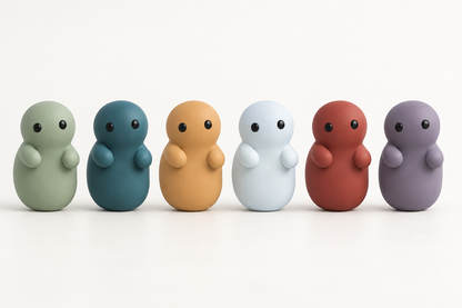 Corbie Series 02, six figures standing in a row on a pale ground, left to right in Meadow green, Reef teal, Leaves amber, Ice white, Ember red and Dusk violet.